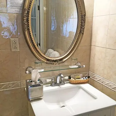 a bathroom with a sink and a mirror at Morris House Hotel in Philadelphia