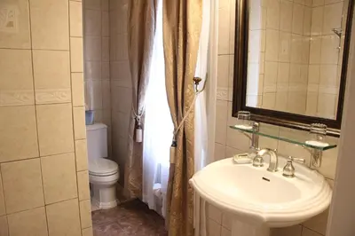 a bathroom with a sink and a toilet and a mirror at Morris House Hotel in Philadelphia