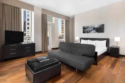 a bedroom with a bed and a couch and a tv at Hotel 57 in New York