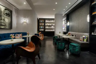 a restaurant with tables and chairs and a couch at Hotel 57 in New York