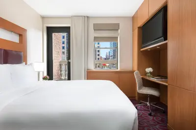 a hotel room with a bed and a desk and a window at Hotel 57 in New York