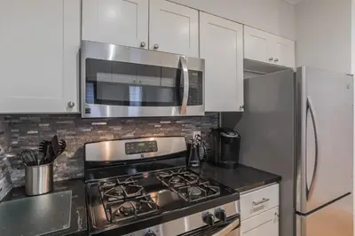 a kitchen with a stove and a microwave at Beautiful 2 bedroom-Graduate Hospital-Back Patio in Philadelphia