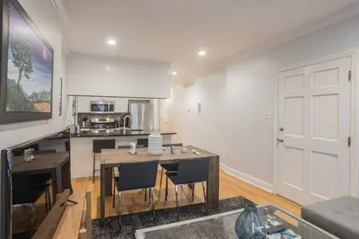 a living room with a table and a kitchen at Beautiful 2 bedroom-Graduate Hospital-Back Patio in Philadelphia