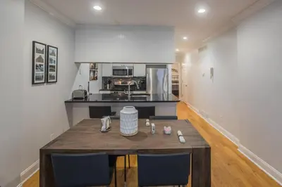 a kitchen with a wooden table in a room at Beautiful 2 bedroom-Graduate Hospital-Back Patio in Philadelphia