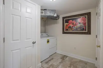 a kitchen with a white door and a painting on the wall at Beautiful 2 bedroom-Graduate Hospital-Back Patio in Philadelphia