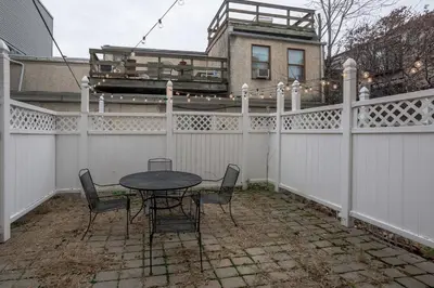 a patio with a table and chairs on a fence at Beautiful 2 bedroom-Graduate Hospital-Back Patio in Philadelphia
