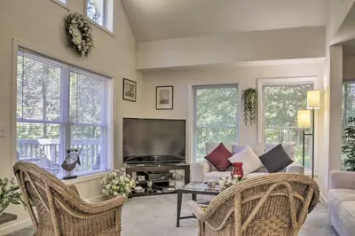 a living room with a couch and a tv at Spacious Home with Deck, Grill and Delaware River View in Callicoon