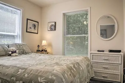 a bedroom with a bed and a large window at Spacious Home with Deck, Grill and Delaware River View in Callicoon