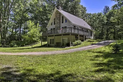 a large house on a hill with trees at Spacious Home with Deck, Grill and Delaware River View in Callicoon