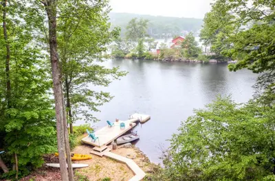 a boat parked on the side of a lake at Waterfront Highland Lake Home with Deck and Dock in Highland Lakes