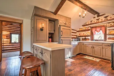 a large kitchen with wooden cabinets and a counter top at Macungie Cabin with Fireplace Near Bear Creek Skiing in Macungie