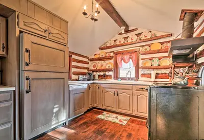 a kitchen with wooden cabinets and a refrigerator at Macungie Cabin with Fireplace Near Bear Creek Skiing in Macungie