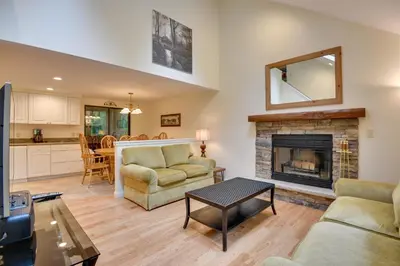 a living room with a couch and a fireplace at Deck and Fire Pit Pocono Lake Home Near Skiing! in Pocono Lake