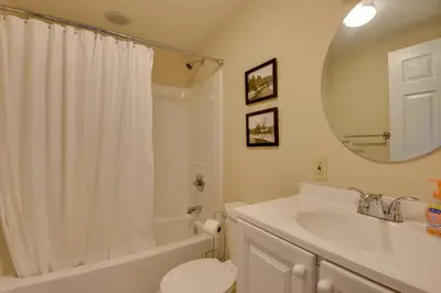 a bathroom with a sink and a toilet and a mirror at Deck and Fire Pit Pocono Lake Home Near Skiing! in Pocono Lake