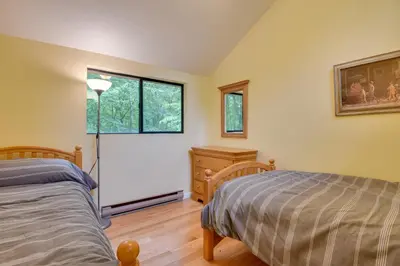 a bedroom with a bed and a window and a dresser at Deck and Fire Pit Pocono Lake Home Near Skiing! in Pocono Lake