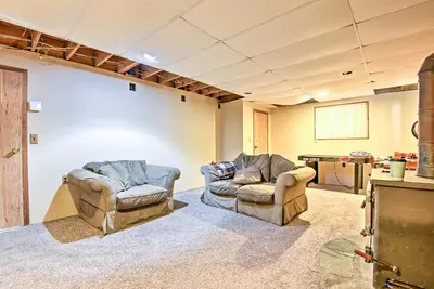 a room with two chairs and a projection screen at Peaceful Hamlin Home with Lake Access at The Hideout in Hamlin