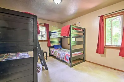 a bedroom with two bunk beds and a bed at Peaceful Hamlin Home with Lake Access at The Hideout in Hamlin