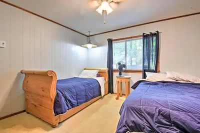 a bedroom with two beds and a window at Peaceful Hamlin Home with Lake Access at The Hideout in Hamlin