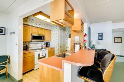a kitchen with an orange counter top and wooden cabinets at 1 Mi to Big Boulder Lakefront Unit with Pool Access in Lake Harmony
