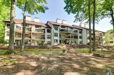 an apartment building with trees in front of it at 1 Mi to Big Boulder Lakefront Unit with Pool Access in Lake Harmony