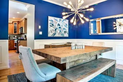 a dining room with a wooden table and blue walls at Colonial-Style Warwick Retreat - 1 Hour to NYC! in Warwick