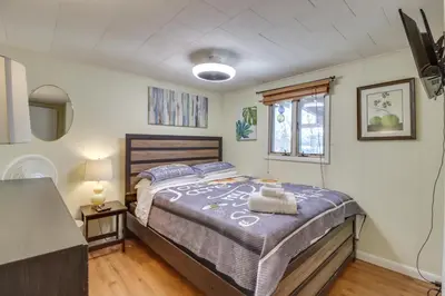 a bedroom with a large bed with two towels on it at Happy Place by the Lake with Fire Pit Walk to Beach in Pocono Lake