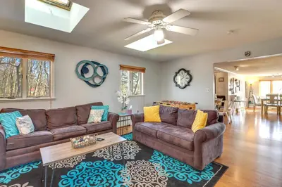 a living room with two couches and a ceiling fan at Happy Place by the Lake with Fire Pit Walk to Beach in Pocono Lake