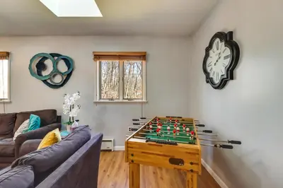 a living room with a table with a chess board on it at Happy Place by the Lake with Fire Pit Walk to Beach in Pocono Lake