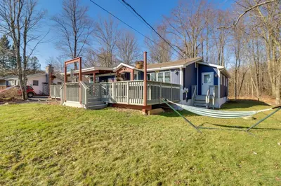 a tiny house with a hammock in the yard at Happy Place by the Lake with Fire Pit Walk to Beach in Pocono Lake
