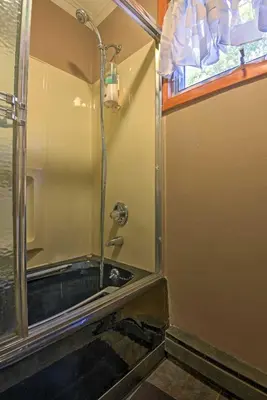 a shower in a bathroom with a sink at 1 Mi to Lake Wallenpaupack Pocono Mountain Home! in Greentown