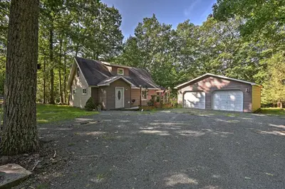 an old house with a garage and a driveway at 1 Mi to Lake Wallenpaupack Pocono Mountain Home! in Greentown
