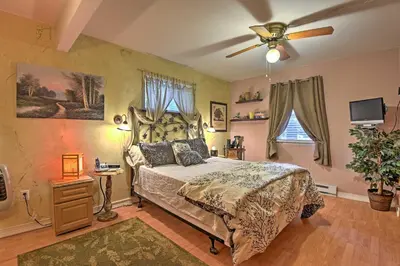 a bedroom with a bed and a ceiling fan at 1 Mi to Lake Wallenpaupack Pocono Mountain Home! in Greentown