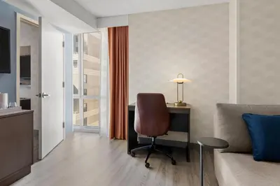 a living room with a desk and a chair at Courtyard by Marriott New York Manhattan/Chelsea in New York