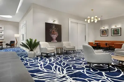 a waiting area with chairs and tables and a waiting room at Courtyard by Marriott New York Manhattan/Chelsea in New York