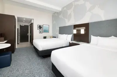 a hotel room with two beds and a desk at Residence Inn by Marriott New York Downtown Manhattan/World Trade Center Area in New York