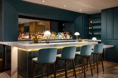 a bar in a hotel with blue bar stools at Residence Inn by Marriott New York Downtown Manhattan/World Trade Center Area in New York