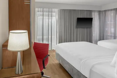 a hotel room with a bed and a desk and a lamp at Fairfield Inn by Marriott New York Manhattan/Financial District in New York