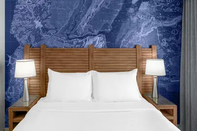 a bed with two white pillows and two lamps at Fairfield Inn by Marriott New York Manhattan/Financial District in New York
