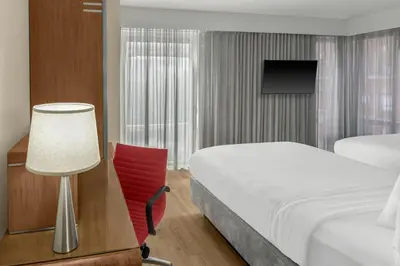 a hotel room with a bed and a desk and a lamp at Fairfield Inn by Marriott New York Manhattan/Financial District in New York