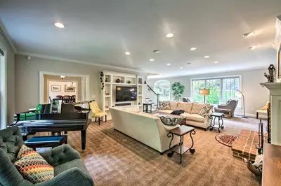a living room with a piano and a couch at Extravagant Atglen Manor with Private 60-Acre Land! in Atglen