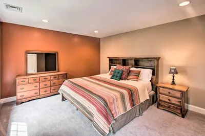 a bedroom with a bed and a dresser and a television at Extravagant Atglen Manor with Private 60-Acre Land! in Atglen
