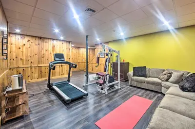 a living room with a couch and a gym at Extravagant Atglen Manor with Private 60-Acre Land! in Atglen