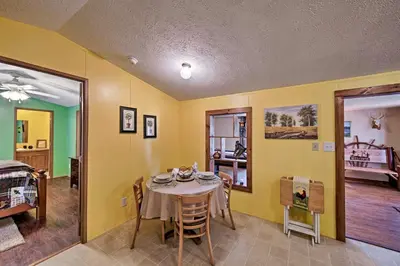 a dining room with a table and a bedroom at 180-Acre Farm The Lodge in Klingerstown! in Klingerstown