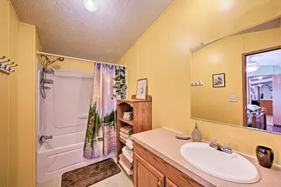a bathroom with a sink and a shower and a tub at 180-Acre Farm The Lodge in Klingerstown! in Klingerstown