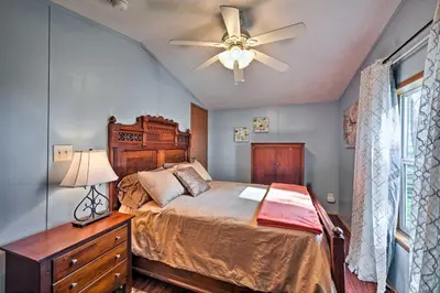 a bedroom with a bed and a ceiling fan at 180-Acre Farm The Lodge in Klingerstown! in Klingerstown