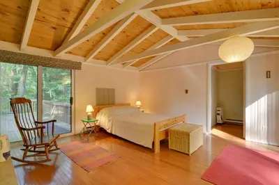 a bedroom with a bed and a chair in a room at Secluded Stroudsburg Home - 5 Mi to Ski Resort in Stroudsburg