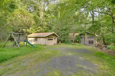 an empty yard with a playground and a house at Secluded Stroudsburg Home - 5 Mi to Ski Resort in Stroudsburg