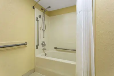 a bathroom with a bath tub and a shower stall at Days Inn by Wyndham Hillsborough in Hillsborough