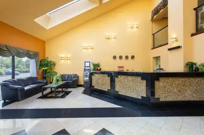 a lobby with a bar in a building at Days Inn by Wyndham Hillsborough in Hillsborough