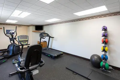a gym with several exercise equipment in a room at Days Inn by Wyndham Hillsborough in Hillsborough
